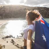 young woman with aussie flag on beach